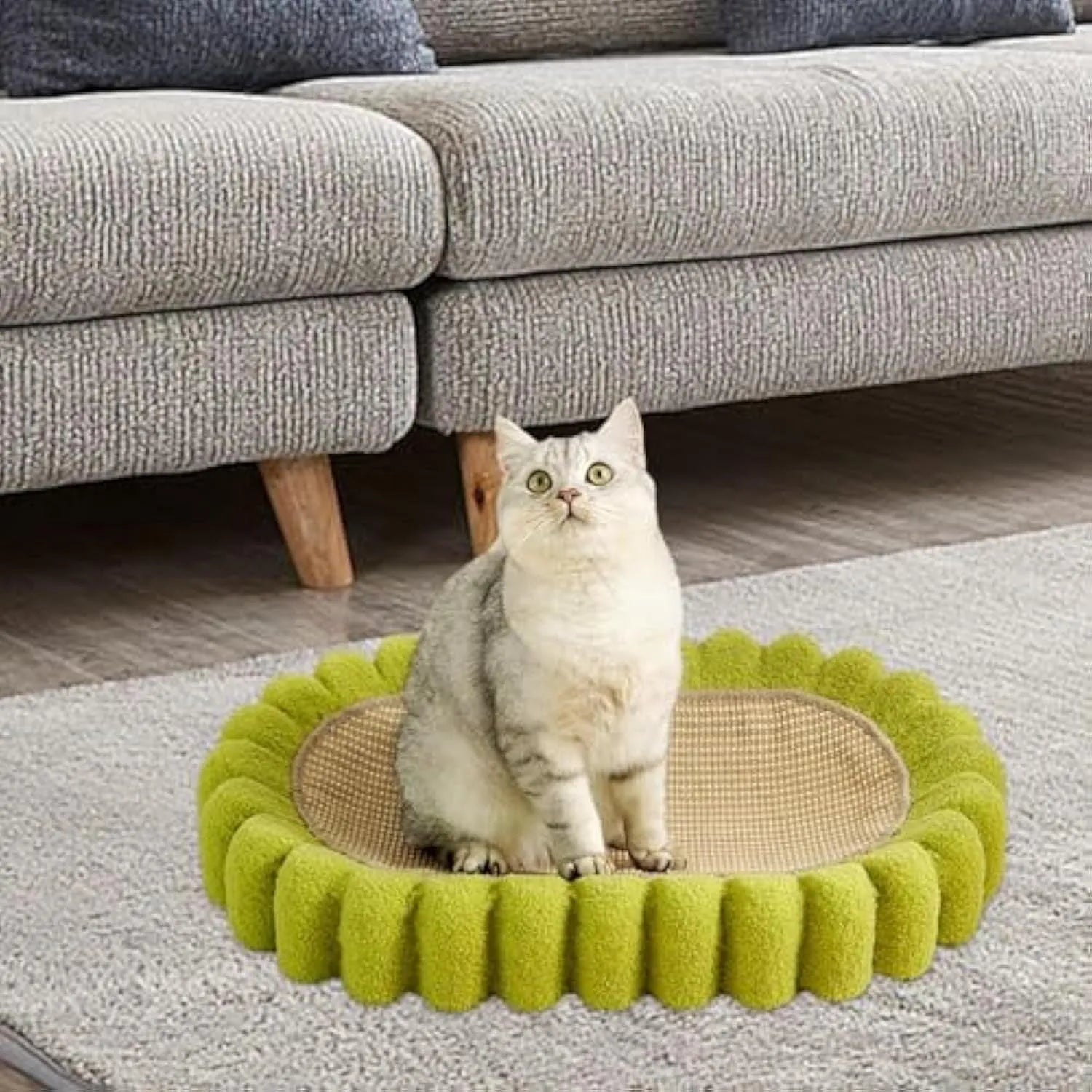Green oval cat scratch pad and bed made from sisal measuring 650x420x100mm