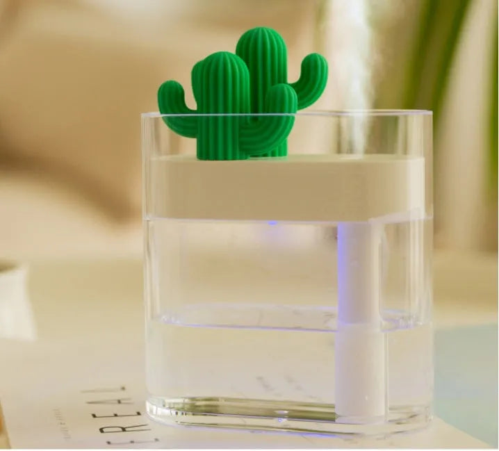 Transparent green cactus USB portable humidifier on desk showing water level inside plastic body