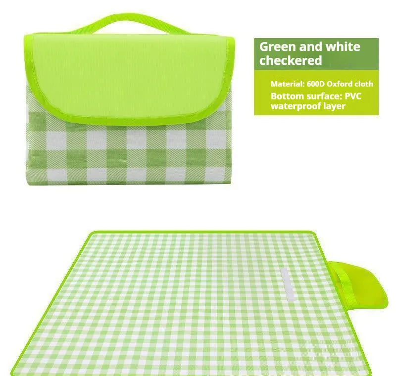 Thickened outdoor picnic mat in green grid non-woven fabric, folded on grass