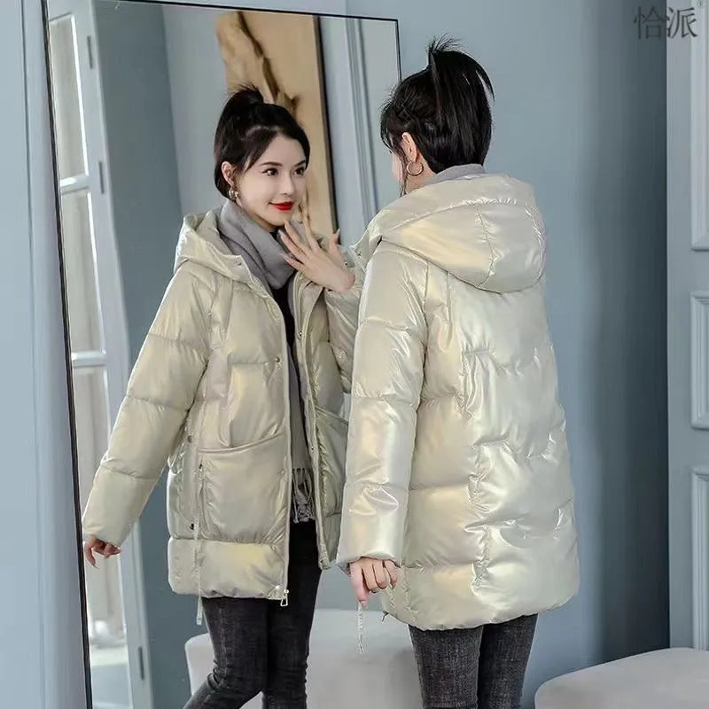 A woman wearing a loose-fit black hooded winter jacket, showcasing its long sleeves and thick construction.