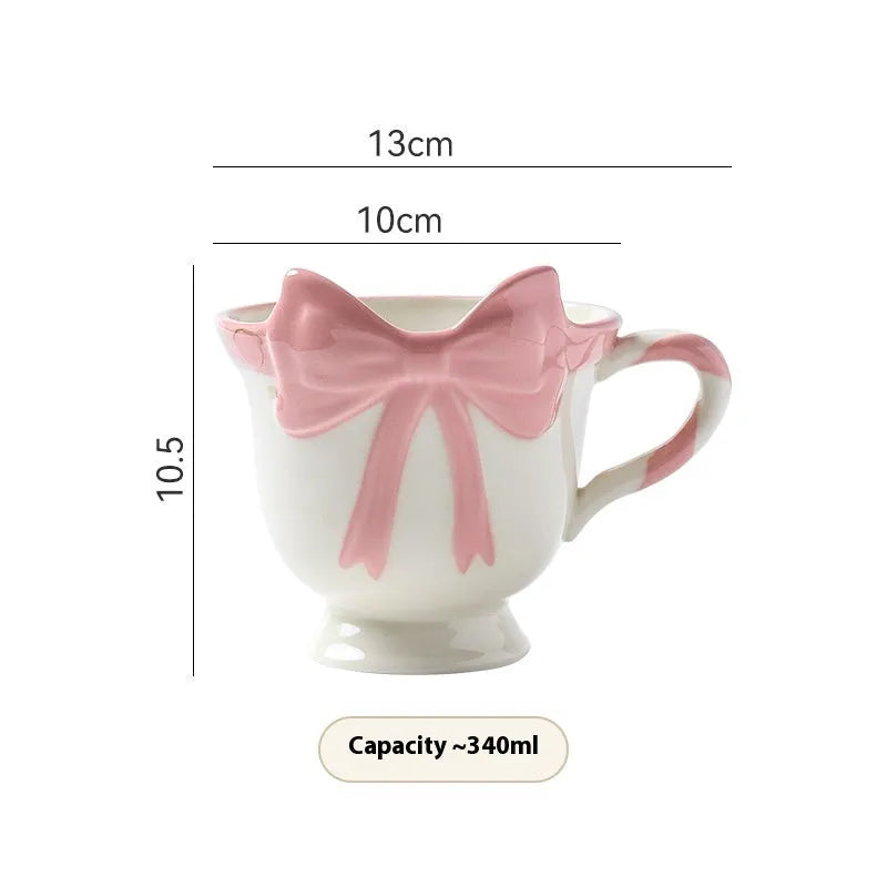 Ceramic mug with girl heart bow decoration in white powder or black pink colour, 301-400ml capacity.