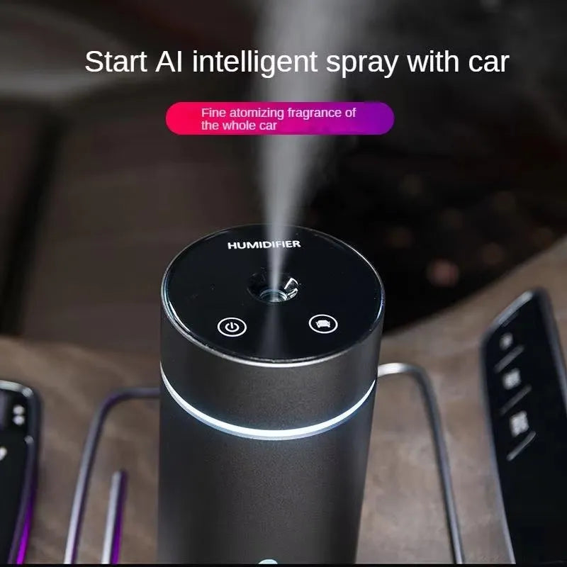 Black A6 aluminium alloy portable car humidifier and essential oil diffuser with USB cable on a desk.