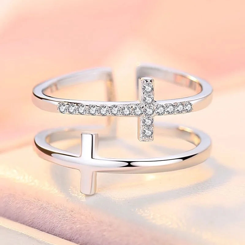 Adjustable copper women's ring featuring a double cross design inlaid with zircon gemstones in a sterling silver setting.