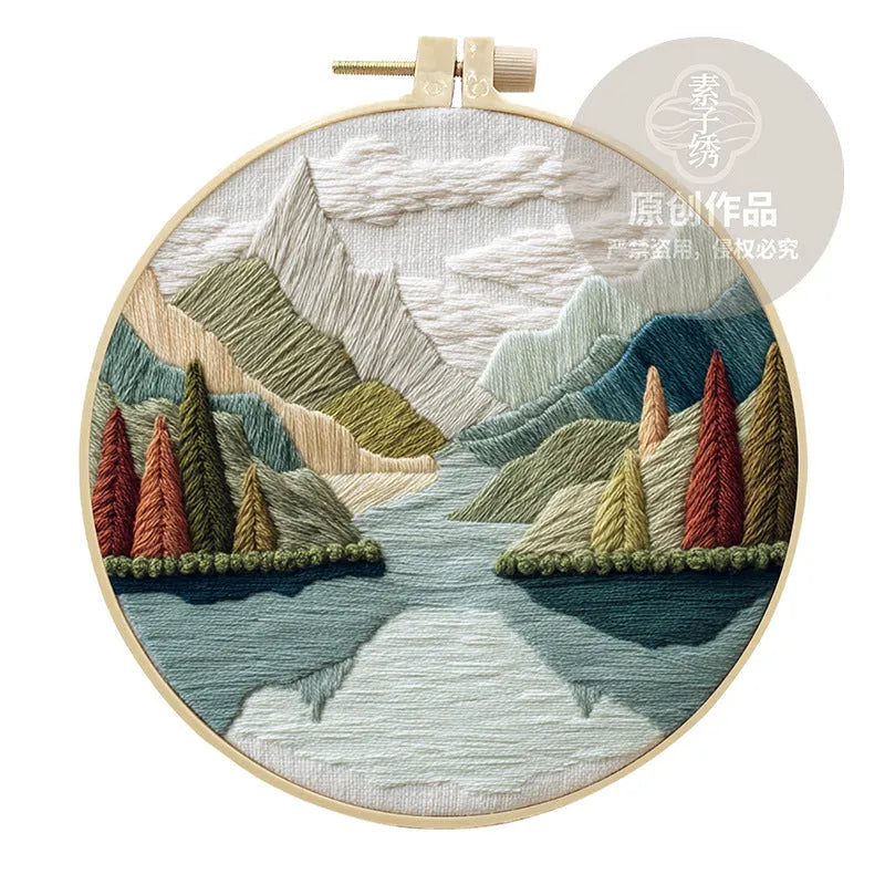 Embroidery DIY landscape kit with cotton fabric, bamboo frame, threads, and needles for handmade cloth art.