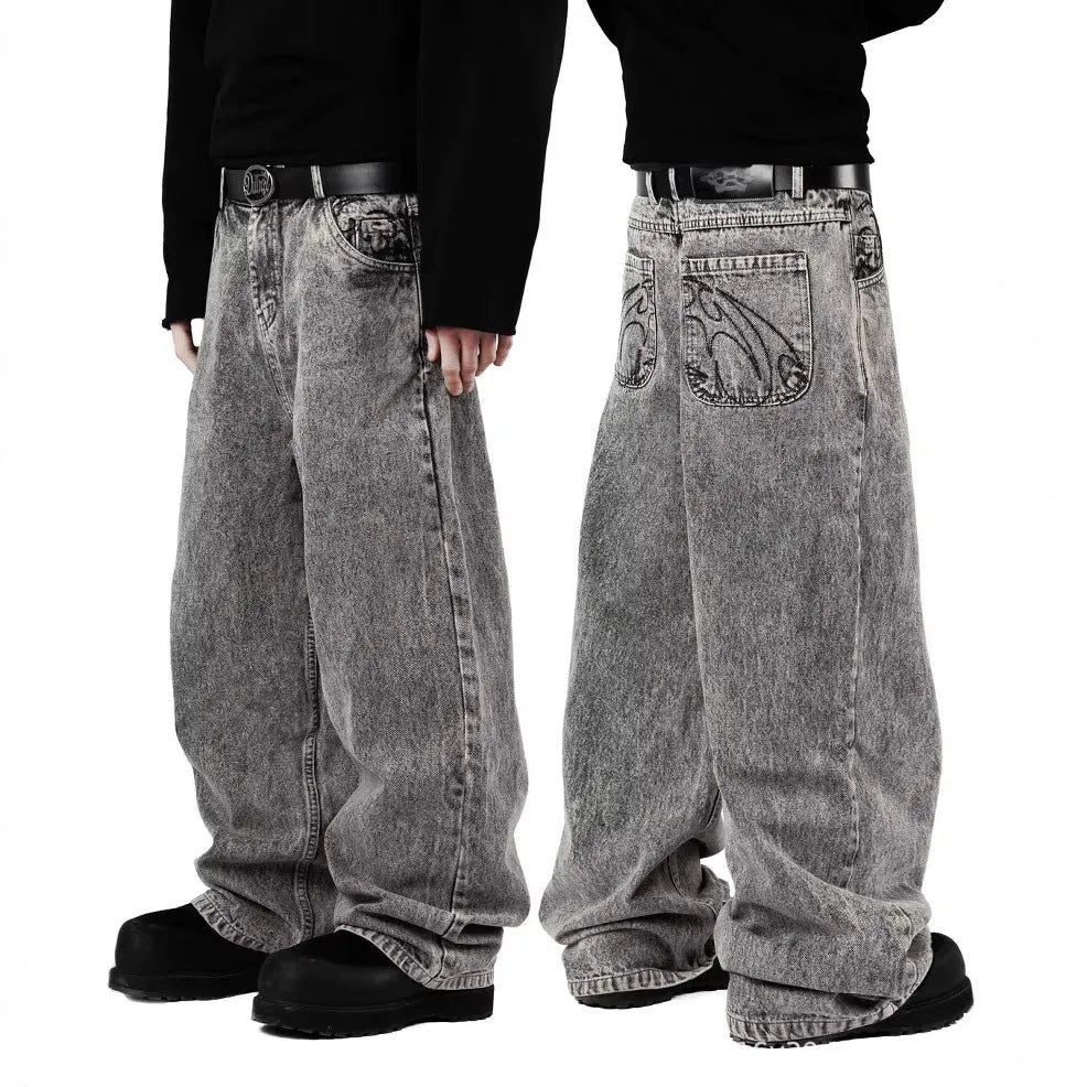 Grey loose fit straight leg denim trousers for men and women on a plain background