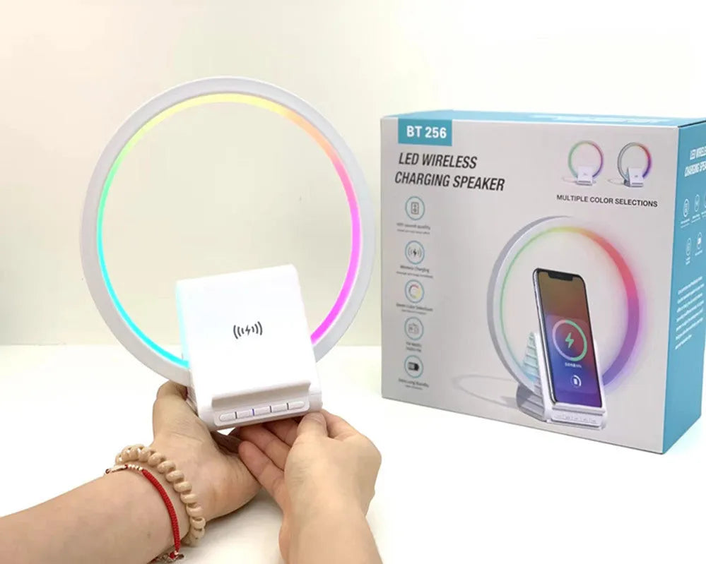 White smart Bluetooth speaker with built-in ambient light and 15W wireless charging pad on top.