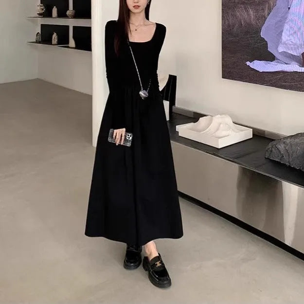 Black knitted square collar dress with long sleeves and an A-line long skirt on a model.