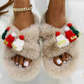 Women's slippers with a Christmas hat decoration on a super hairy faux plush upper, shown in black.