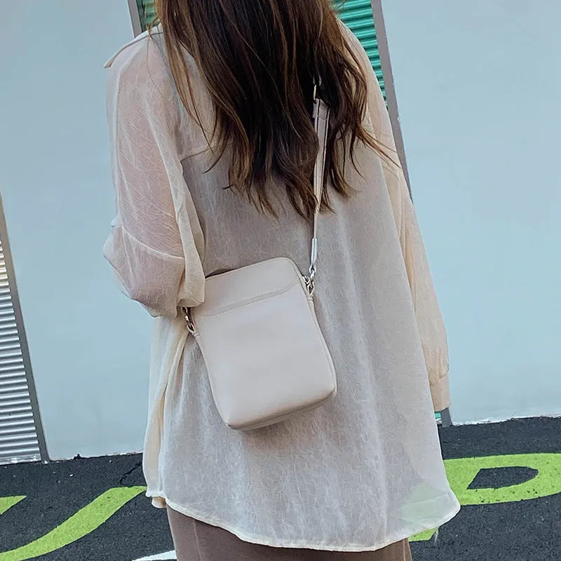 Solid colour PU leather mobile phone shoulder bag showing crossbody and shoulder carry options