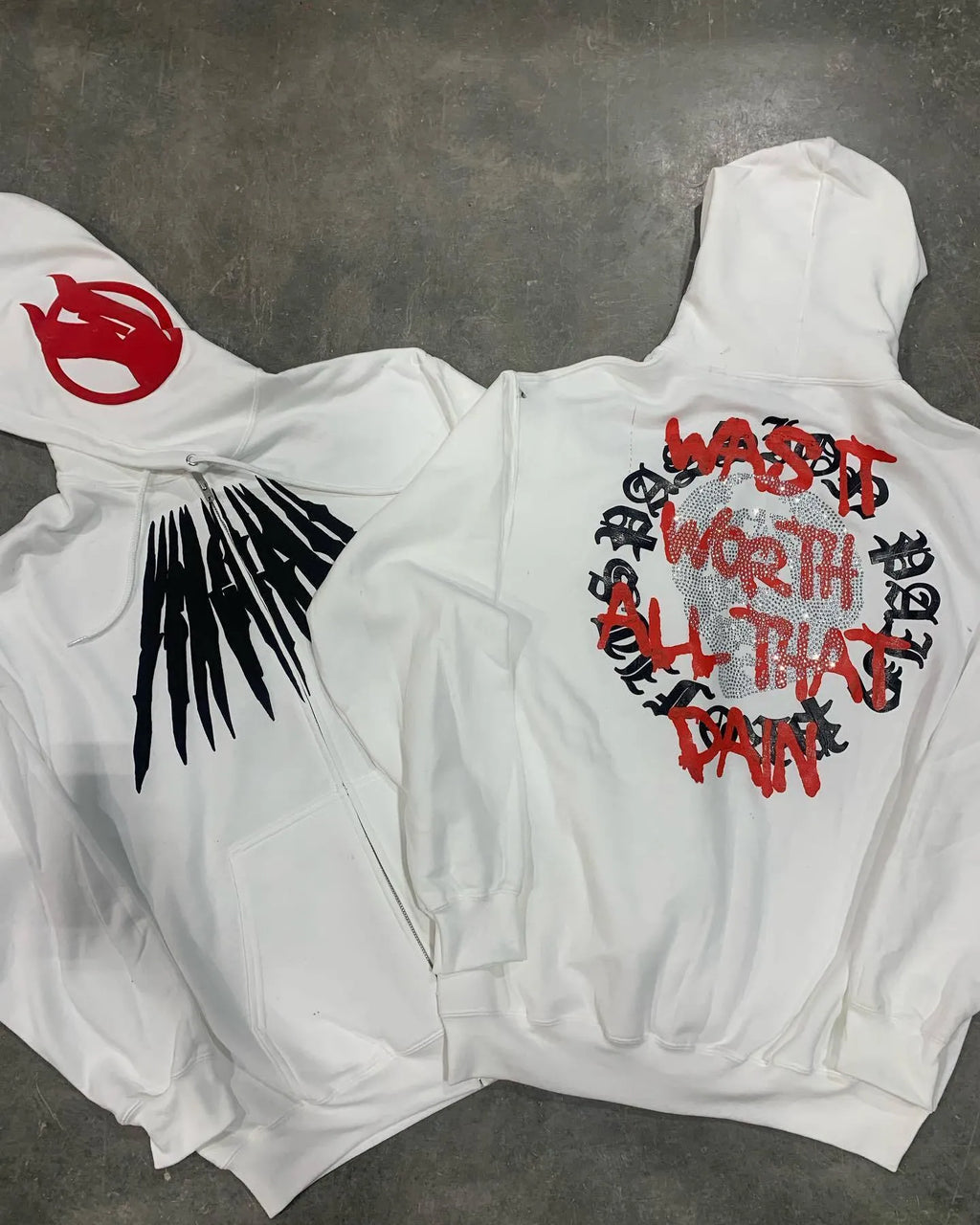 Black loose hooded sweatshirt with printed skull design and rhinestone accents
