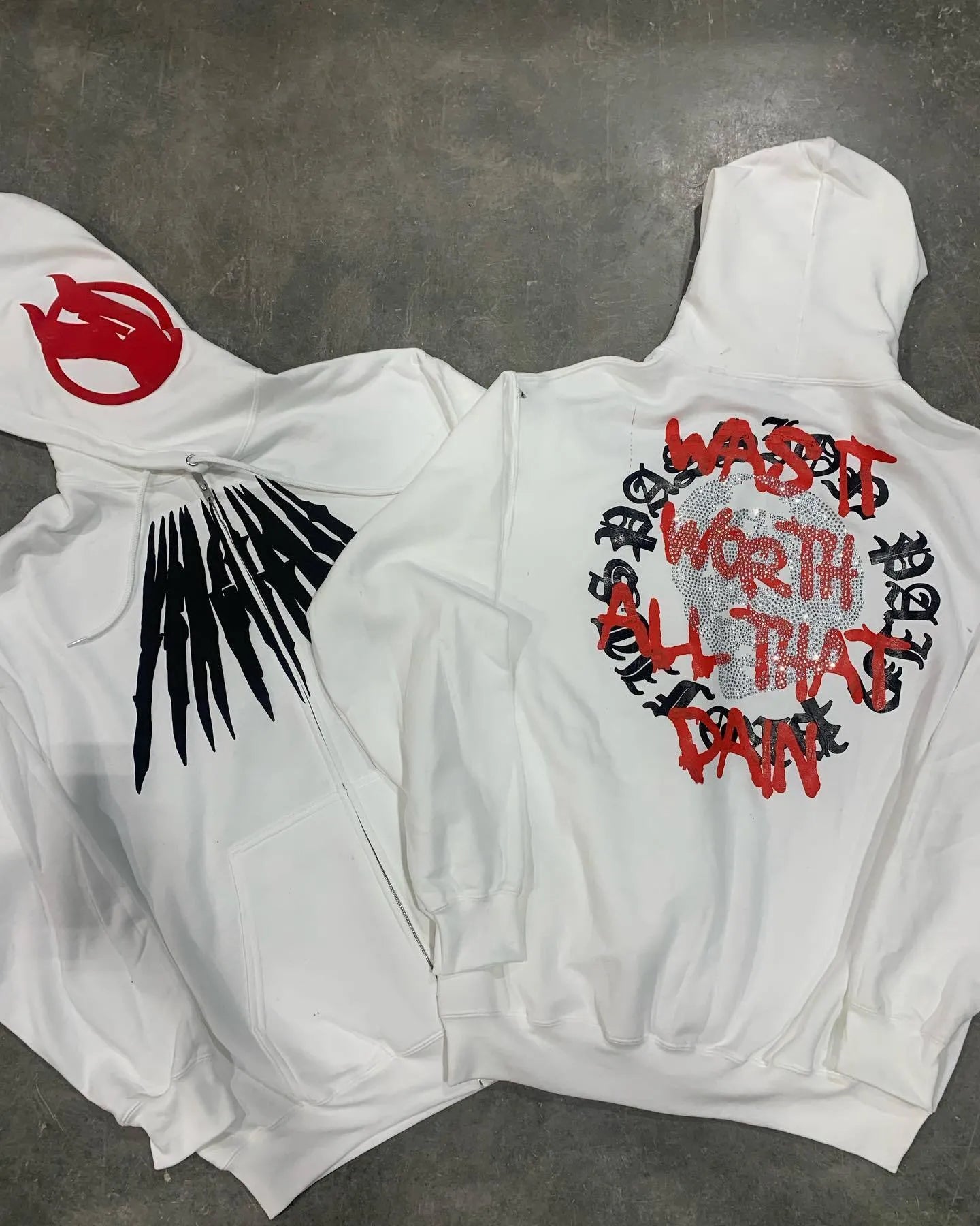 Black loose hooded sweatshirt with printed skull design and rhinestone accents