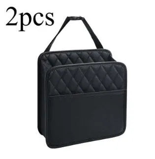 Leather hanging car storage bag and trash can in black, shown mounted behind a car seat