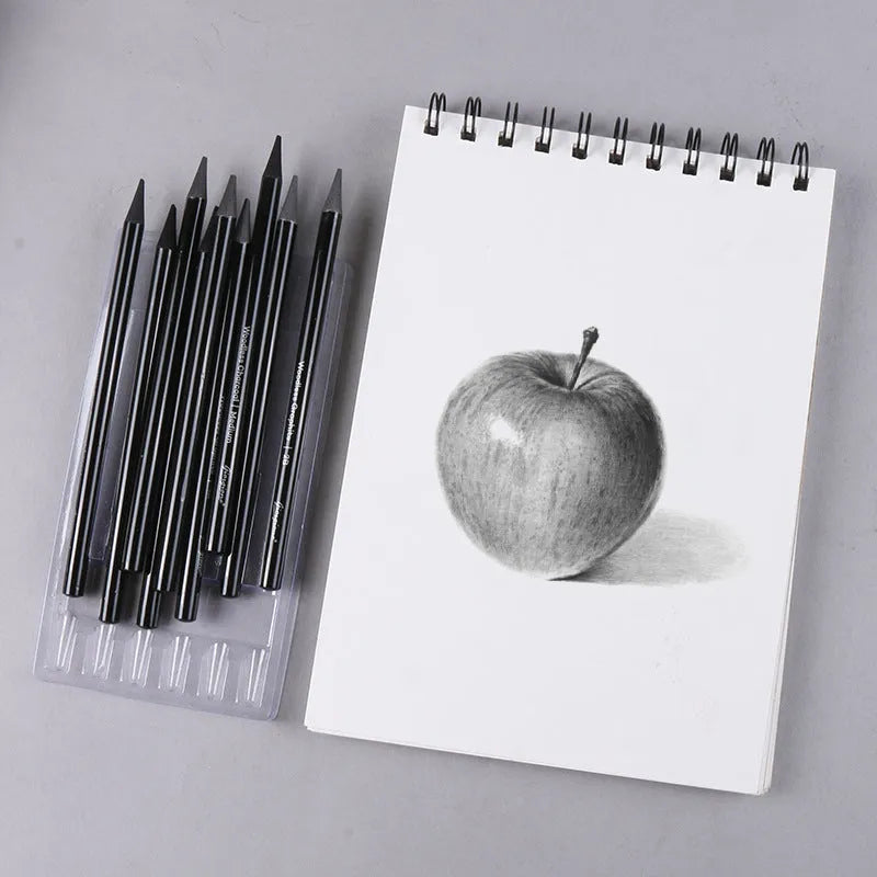 Set of six graphite pencils and three carbonized pencils in wooden casings on suction card packaging.