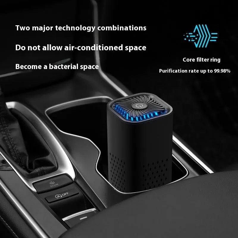 Compact black and white mini USB car air purifier with filter for small spaces.
