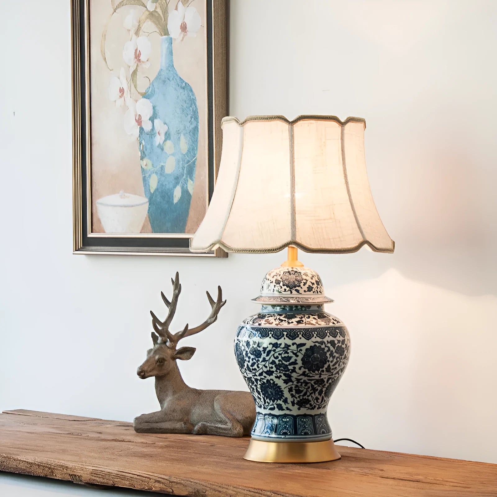 Blue and white porcelain Chinese table lamp with copper base and cloth shade on bedside table