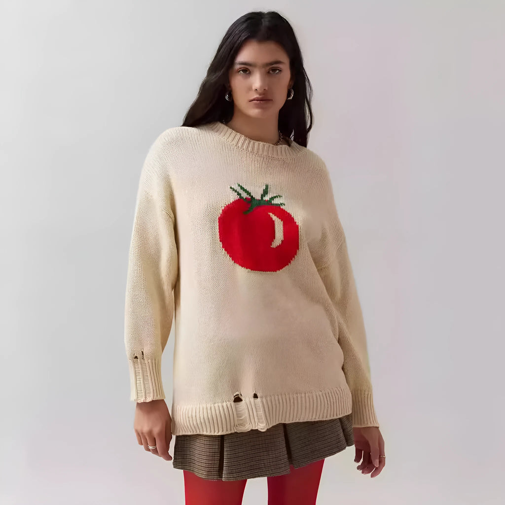 Women's loose-fitting beige jacquard knit sweater on a hanger, showing round neck and long sleeves.