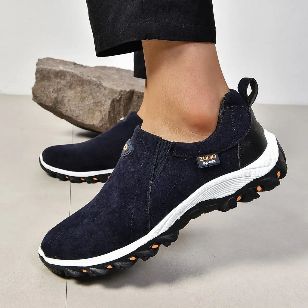 Men's thin grey overshoes with round toe, rubber sole, and shallow mouth design shown on a foot.