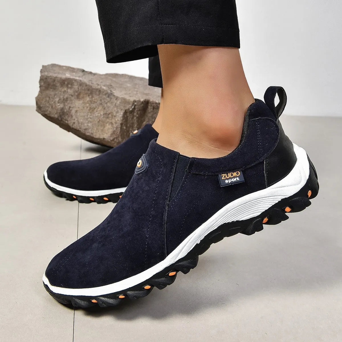 Men's thin grey overshoes with round toe, rubber sole, and shallow mouth design shown on a foot.