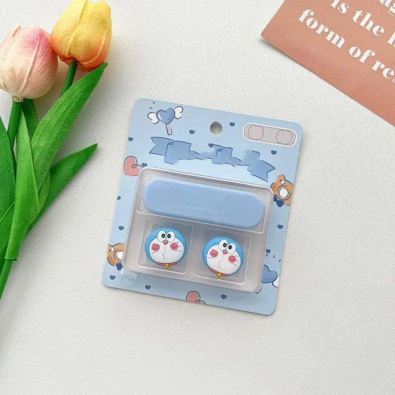 Colourful cartoon character plastic clip holding a magnetic charging cable on a desktop