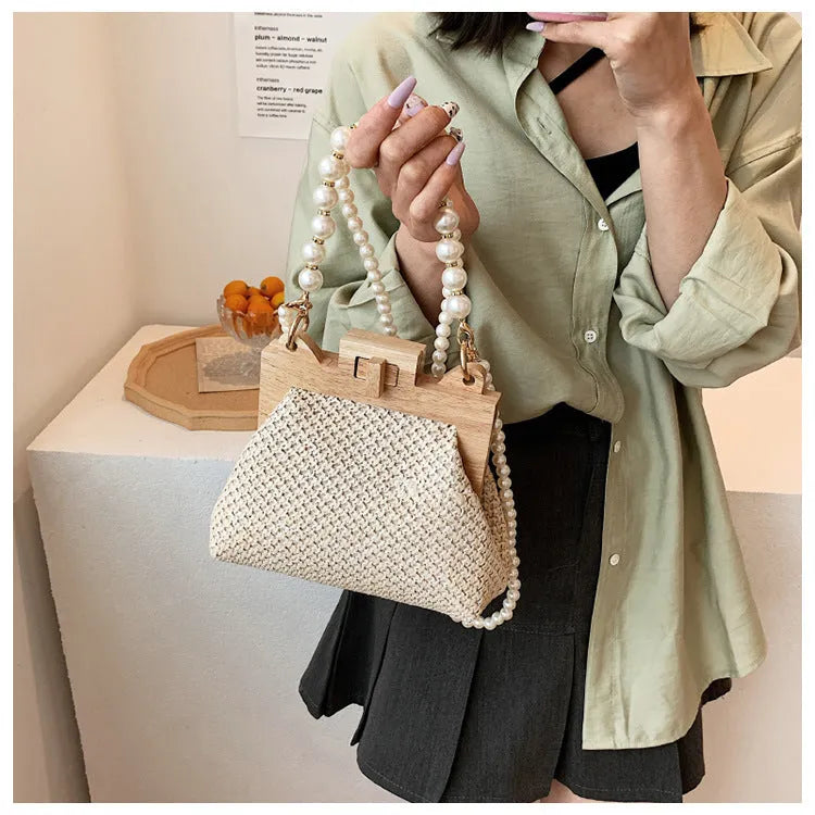 Women's straw woven shoulder bag with beach pearl chain detailing and horizontal square shape