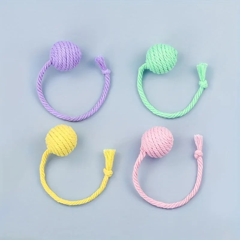 Colourful cat toy ball with an attached rope, shown in green, pink, purple, and yellow with 6cm and 3cm size options.