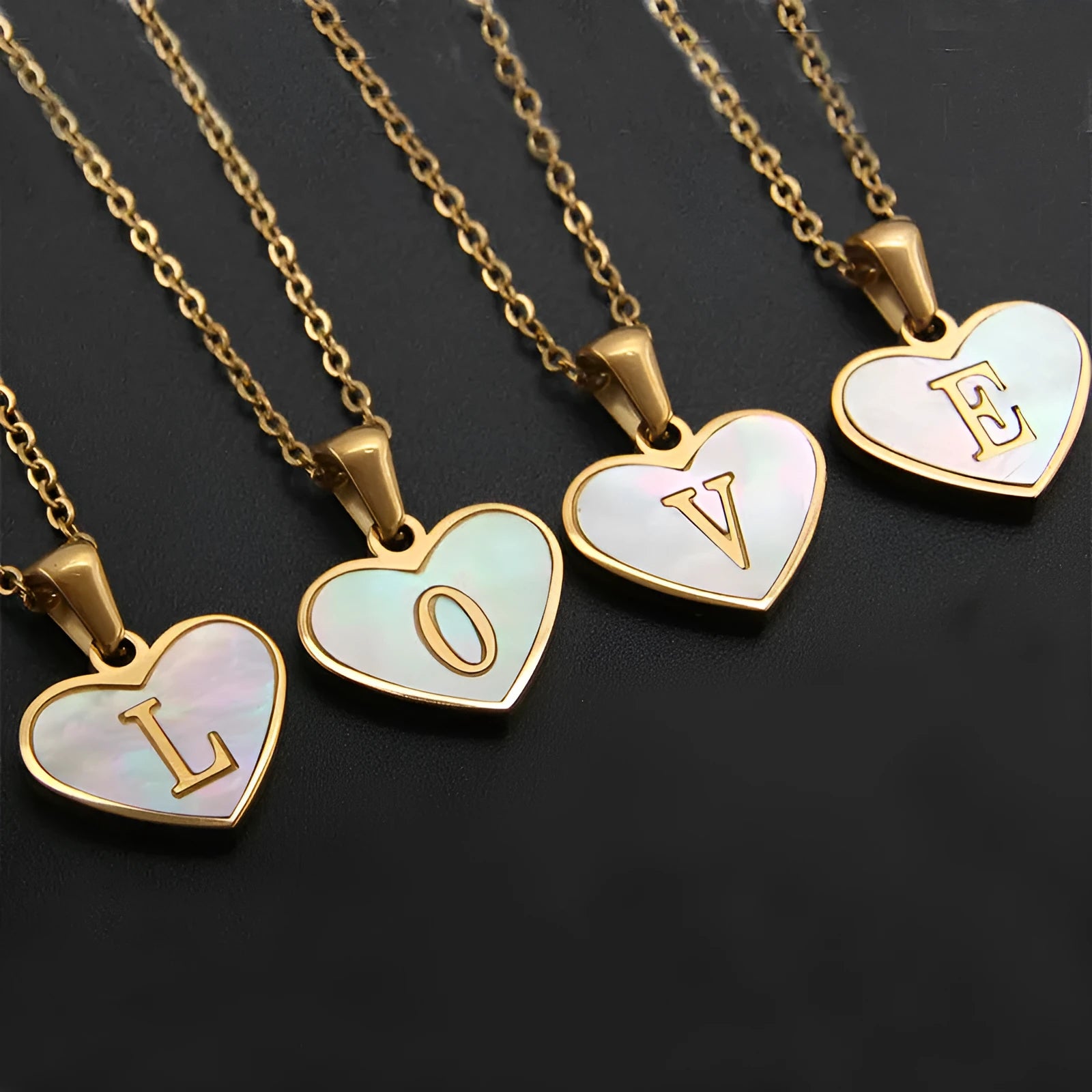 Gold heart-shaped white shell necklace with personalised letter charm on adjustable chain