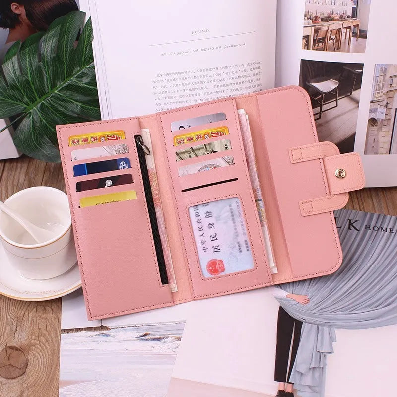 Women's long tri-fold wallet in light grey PU leather with sewing thread detail, open to show multiple card slots and cash compartments.