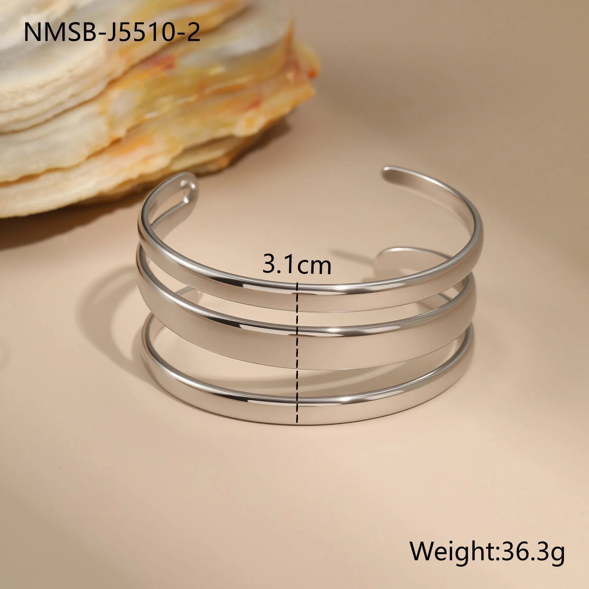 A simple open geometric stainless steel bracelet for women, shown in a gold tone finish.
