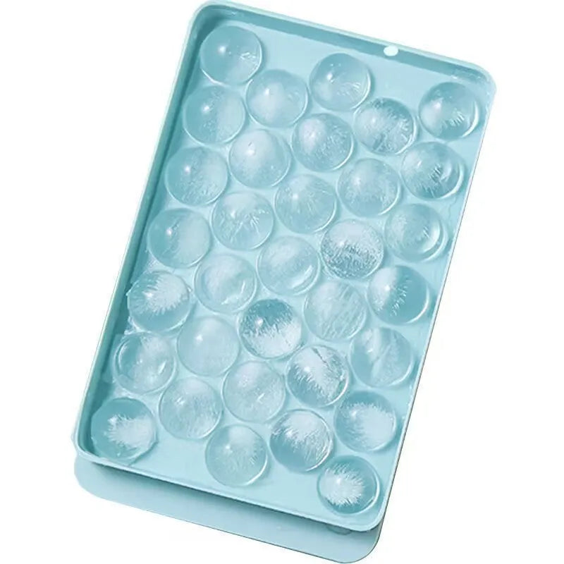 Blue silicone ice cube tray with lid showing 33 round ice cube moulds