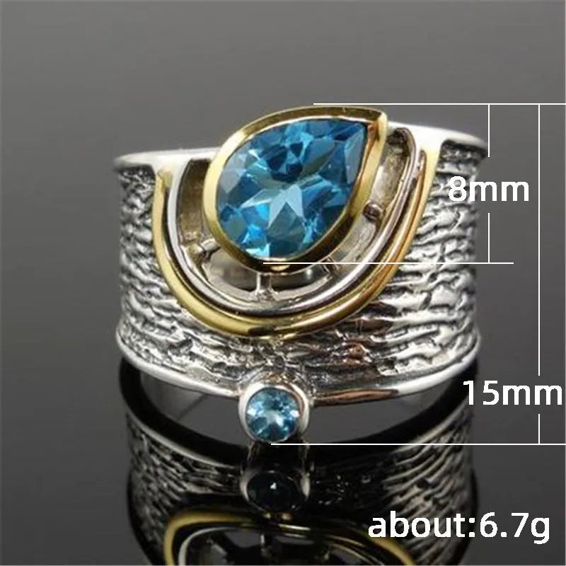 Blue rhinestone zircon drop shape ring on a white background, showing Chinese-inspired alloy design.