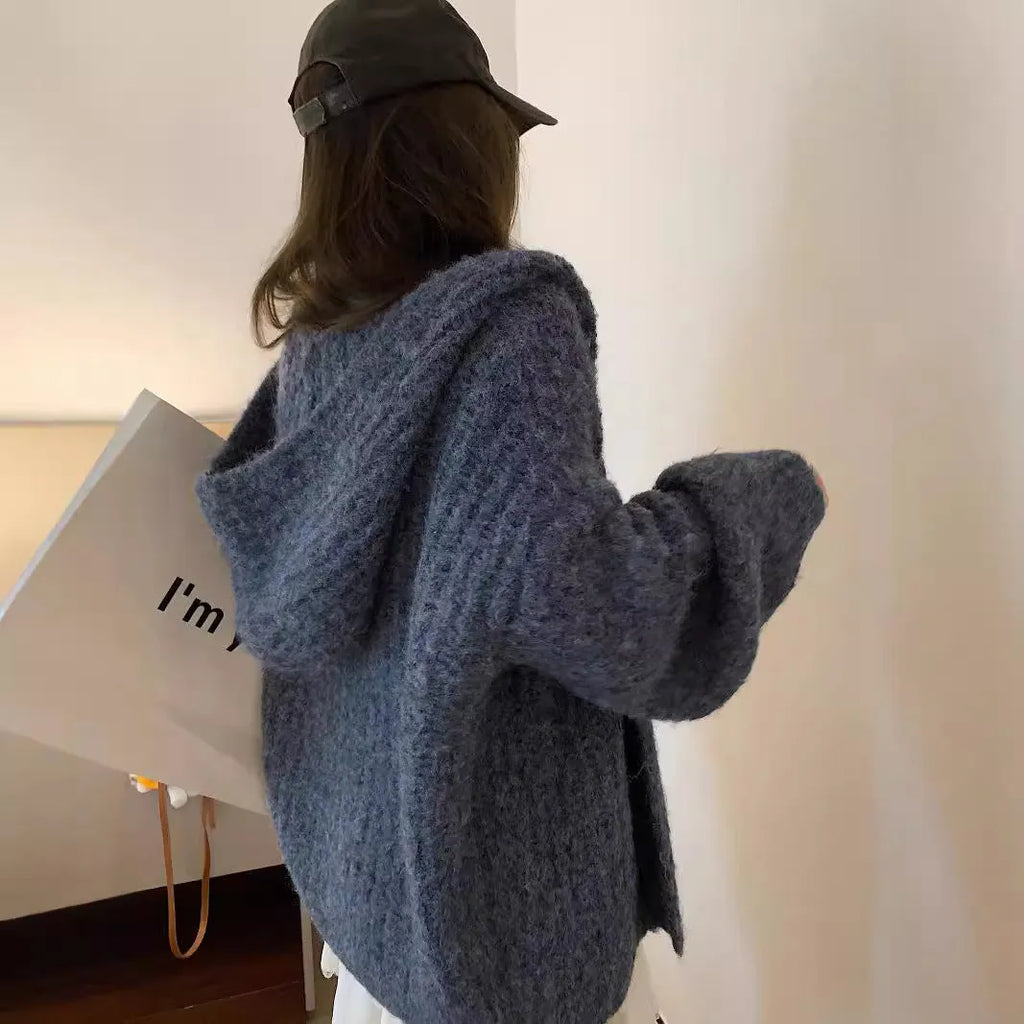Women's dark grey loose-fit hooded cardigan sweater with chunky acrylic knit texture.