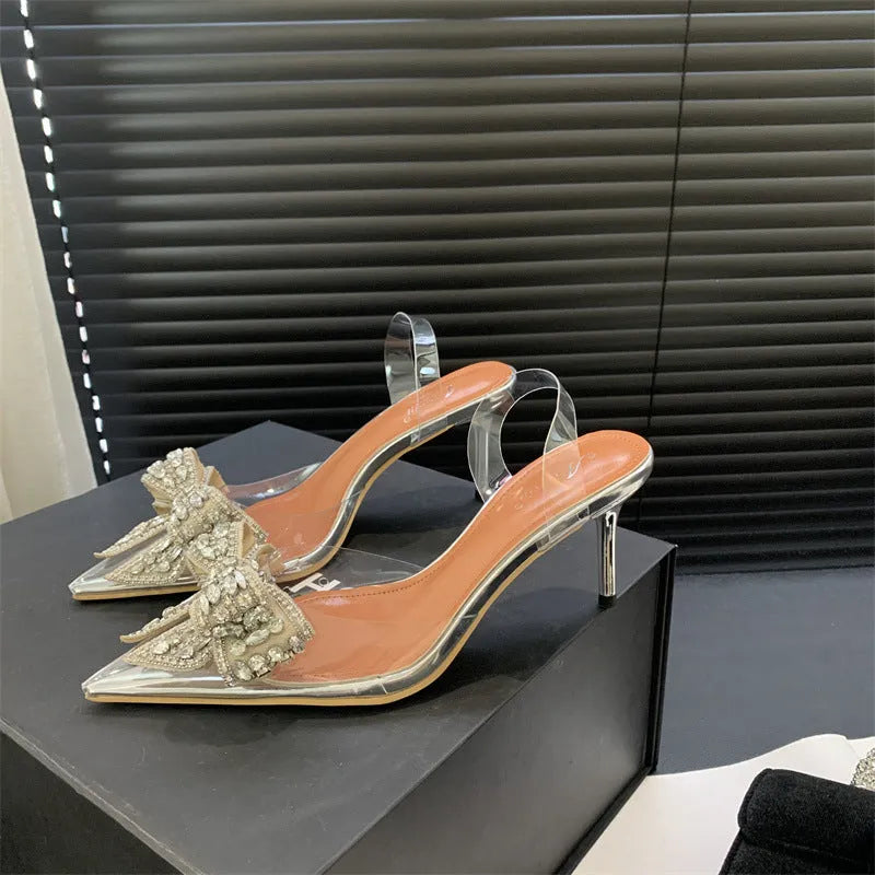 Silver bow rhinestone pointed transparent slip-on high heel sandals with 6-8cm heel and rubber outsole