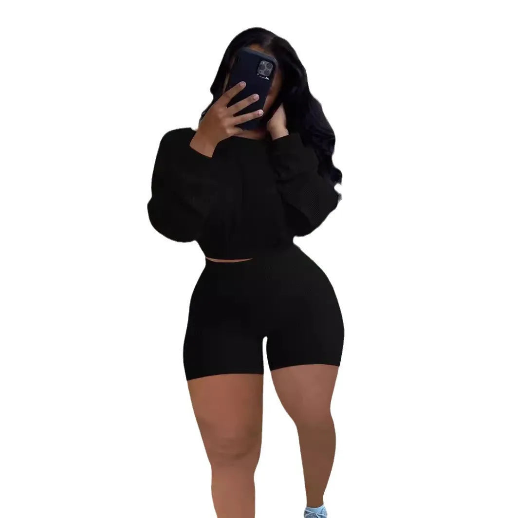 Women's off-the-shoulder long sleeve top and shorts two-piece set in a solid colour with a sunken stripe pattern.