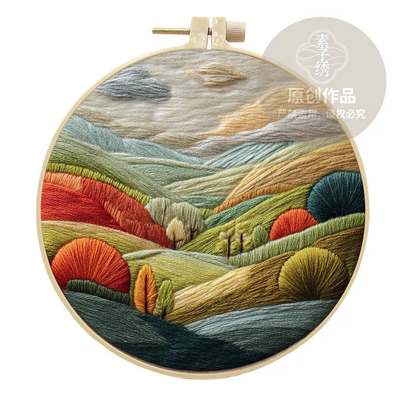 Embroidery DIY landscape kit with cotton fabric, bamboo frame, threads, and needles for handmade cloth art.