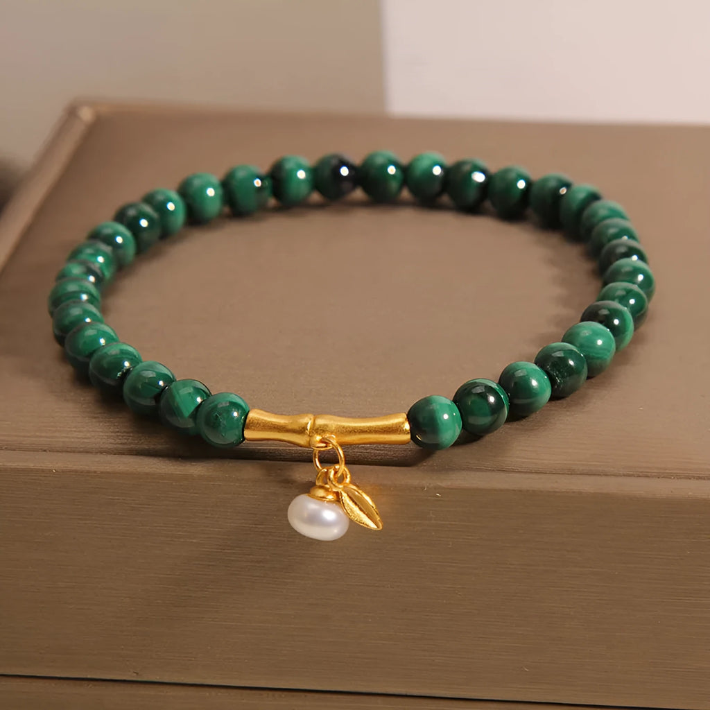 Women's white crystal lucky bamboo bracelet on display