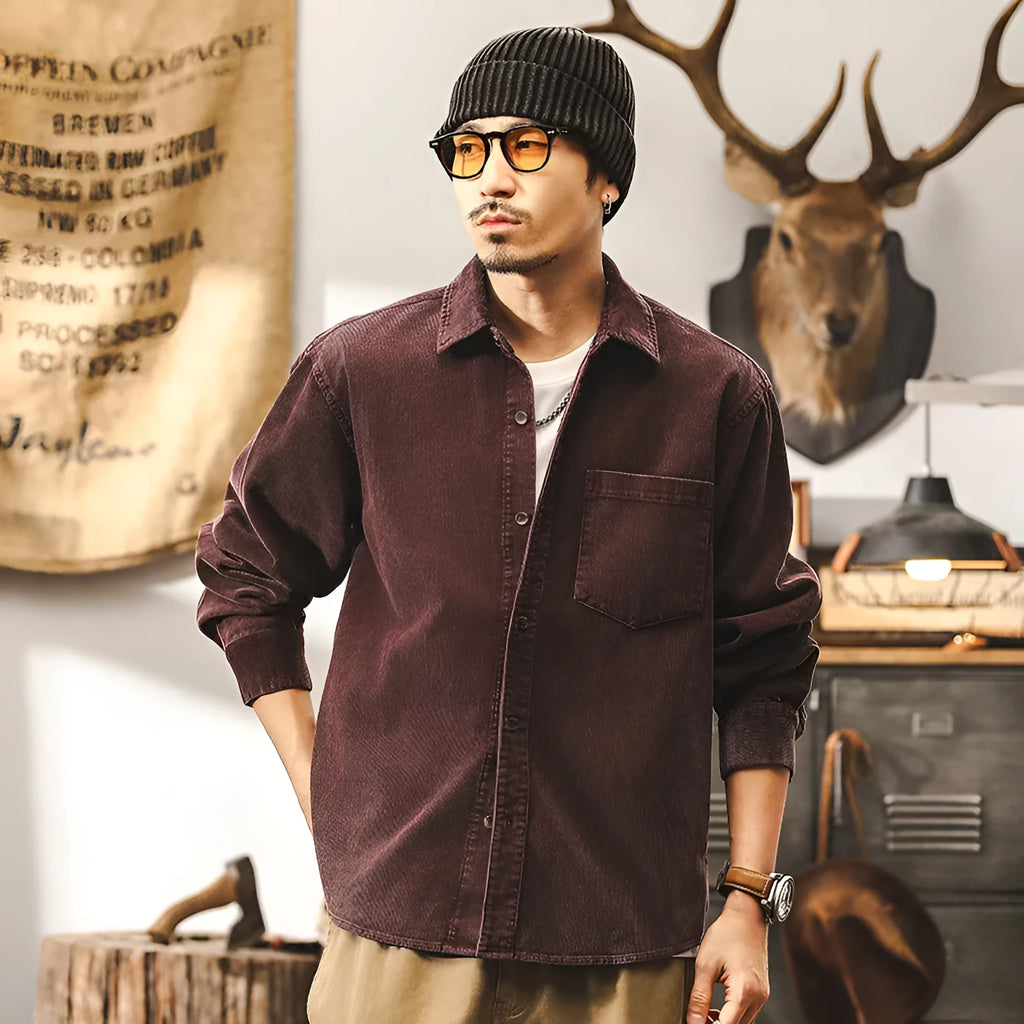 Man wearing a red loose-fit corduroy long sleeve shirt, retro casual style.