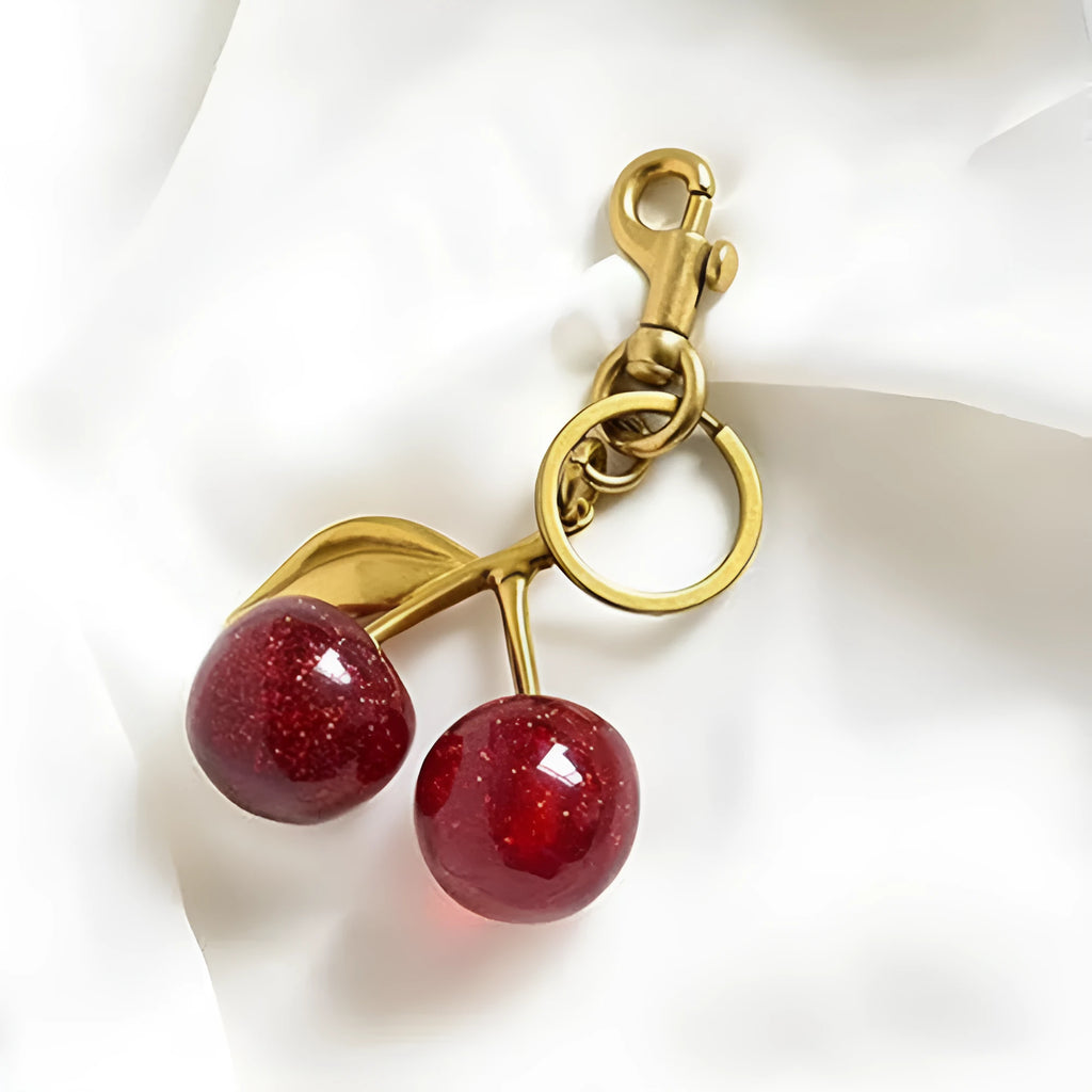 Three-dimensional zinc alloy key ring pendant in pink colour on bag strap
