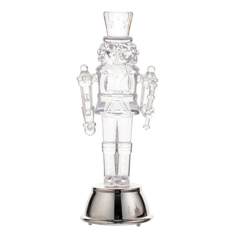 Transparent plastic walnut soldier Christmas nutcracker ornament on a desk.