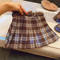 Girls plaid pleated A-line skirt in cotton blend, shown on hanger.