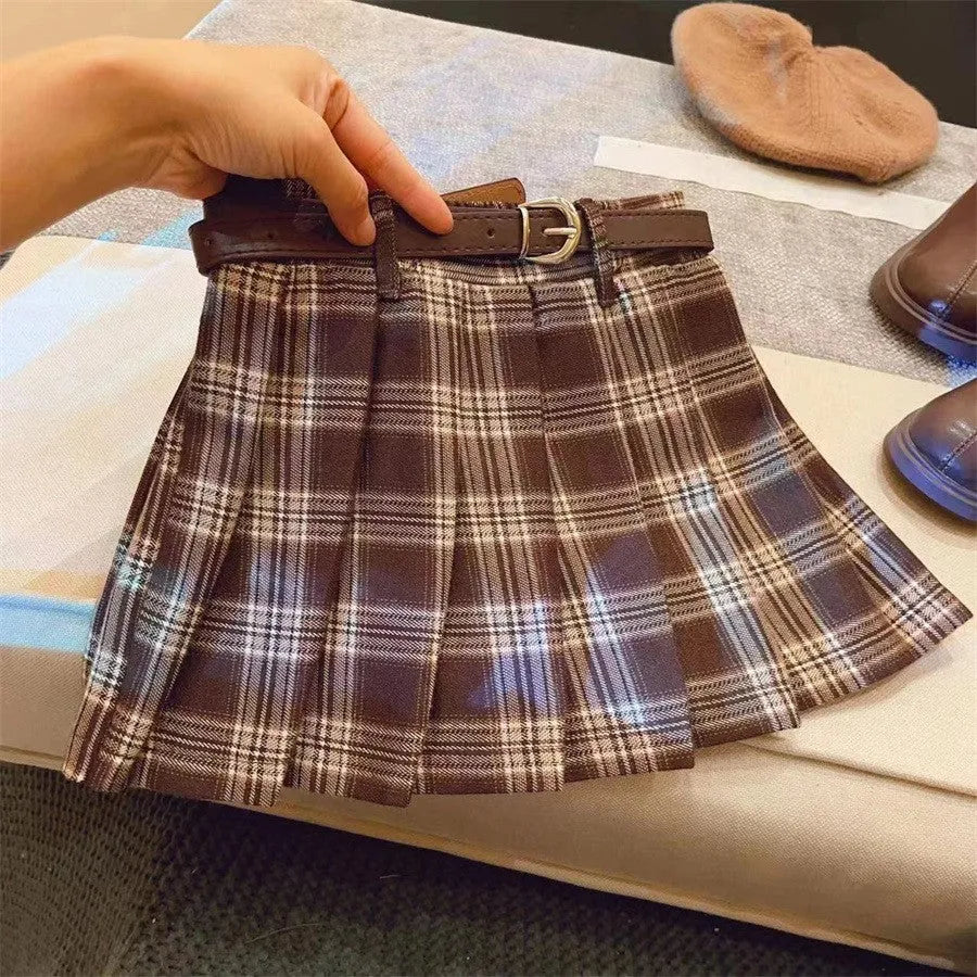 Girls plaid pleated A-line skirt in cotton blend, shown on hanger.