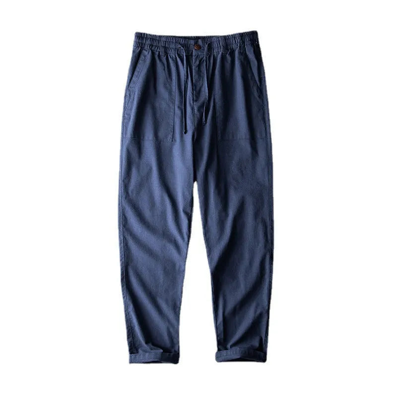 Men's linen casual trousers in navy blue, shown with a mid-waist and standard trouser length.
