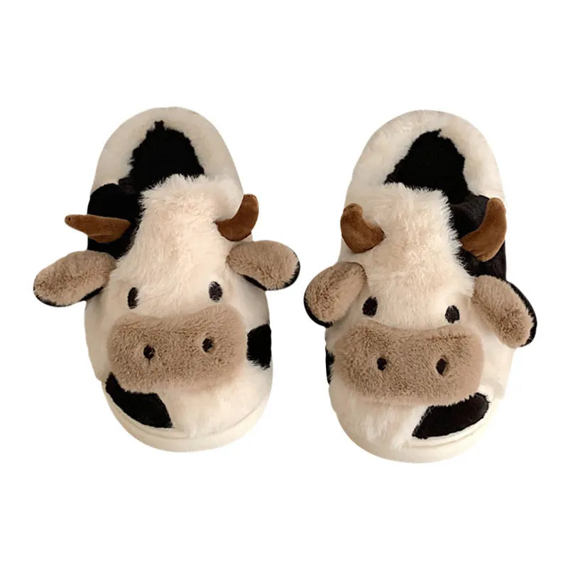 White cartoon cow slippers for women with fluffy faux fur and a textured non-slip sole.