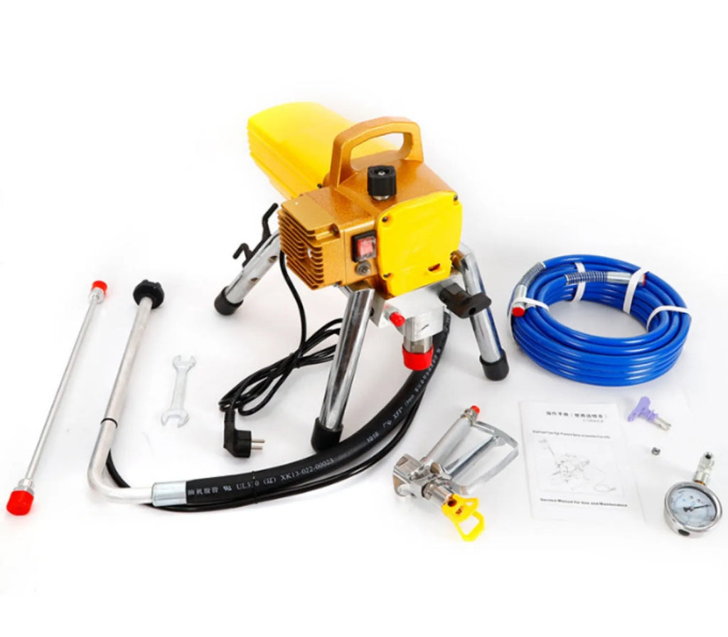 Blue portable electric airless spraying machine with spray gun, hose, extension rod, and accessories on a workbench