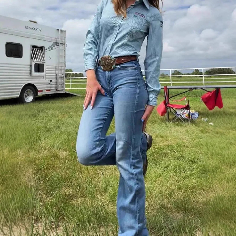 Slim fit blue embroidery jeans with a slight flare and mid-waist on a mannequin.