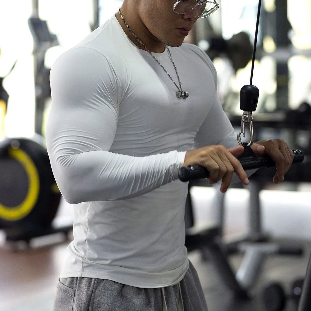 Man wearing black slim-fit long sleeve fitness tights for running or gym workout.